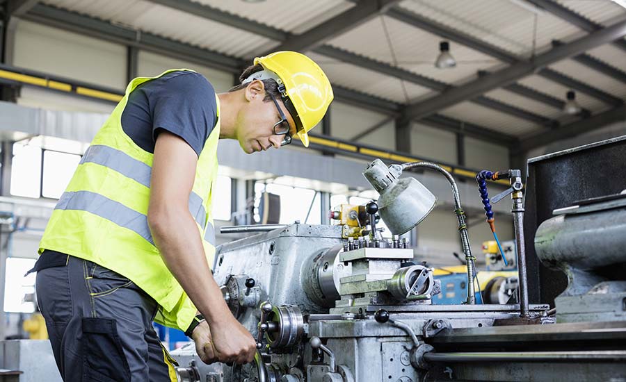 Workers in a heavy manufacturing plant ​